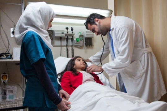 Doctor Examining Little Girl at ER