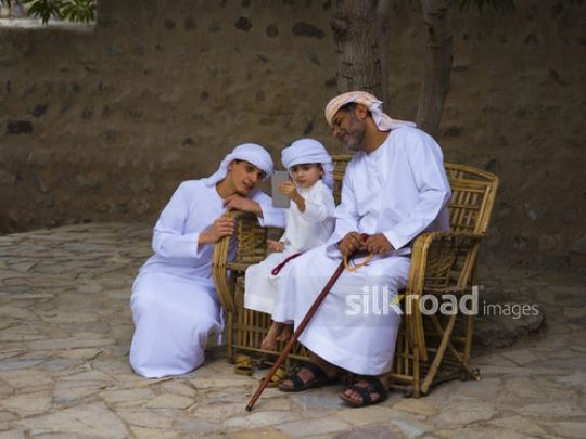 Boy taking selfie with family|-
