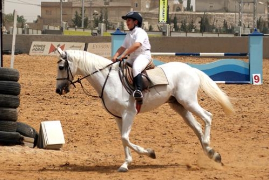 young man riding a horse