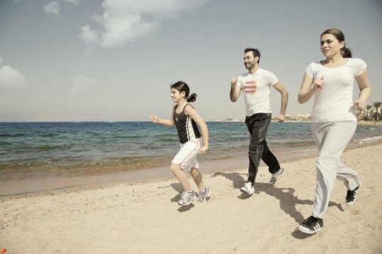 Family Running by the Sea