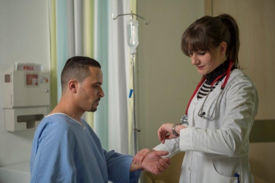 A Woman Doctor Examining Patient at Hospital