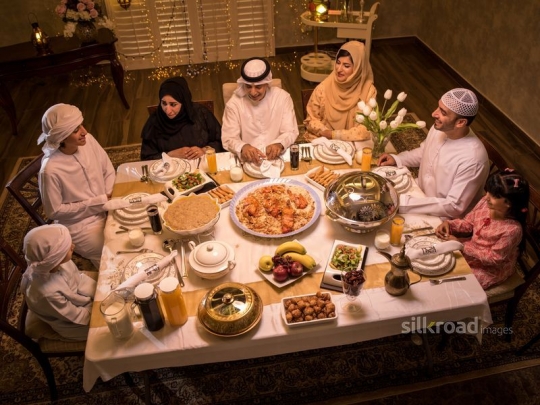 Family gather around iftar table|-
