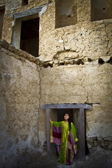 girl with traditional customs standing in an old building