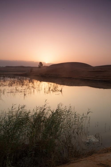 pond with sun reflection in the desert