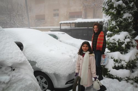 -Children playing with snow in Amman