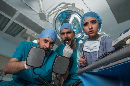 Surgeons Holding Electric Cardioversion and Surgical Tools
