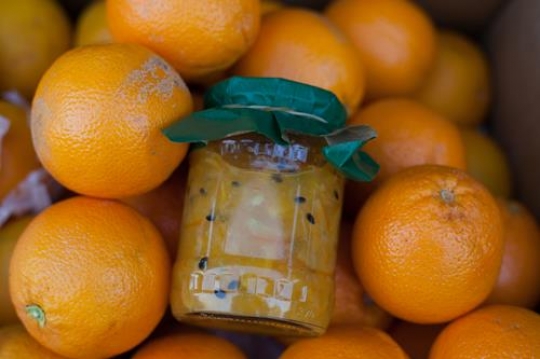 fresh oranges with a bottle of
