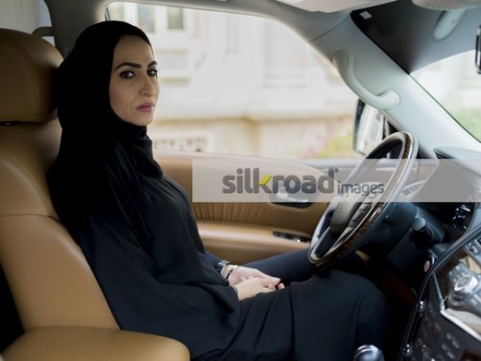 Middle Eastern Businesswoman sitting inside the car|