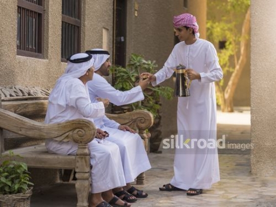 Son offering arab men coffee |-