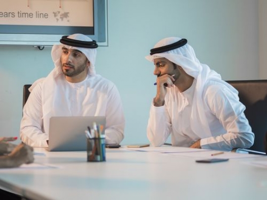 Arab employees during a meeting wearing the traditional attire|-