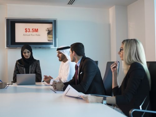 Businesspeople talking to each other during a meeting|-