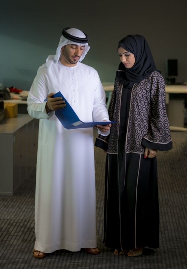 Businessman showing business woman work file|-