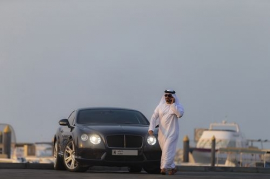 Man in motion walking away from vehicle|-