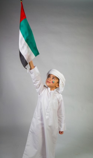 Little boy celebrating raising flag