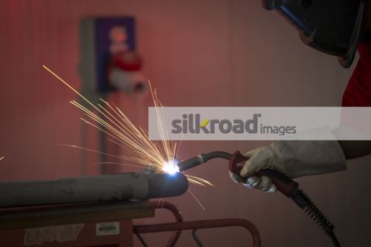 Engineer using machine to cut the metal|