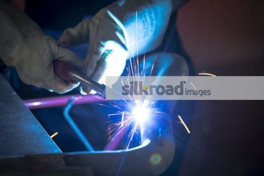 Using the machine to cut through the metal|