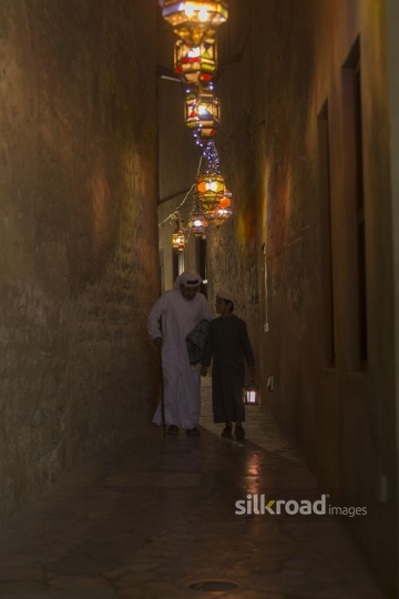 Arab father and son walking together during Ramadan|-