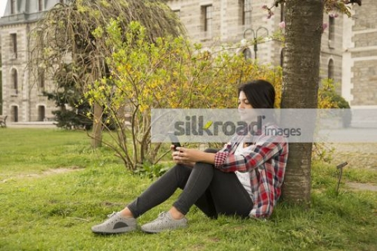 Woman sitting using her mobile|