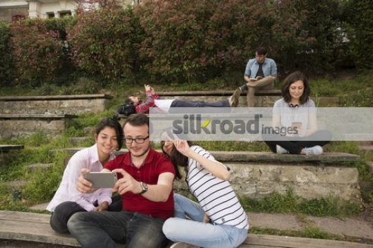Women taking a picture with the man on campus|