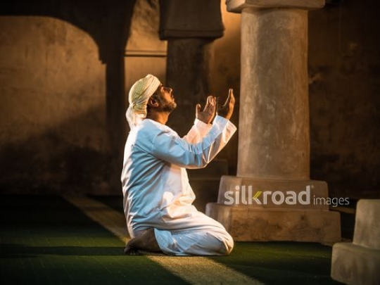 Old man raising hands and praying|-