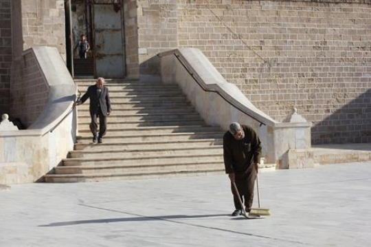 man sweeping street