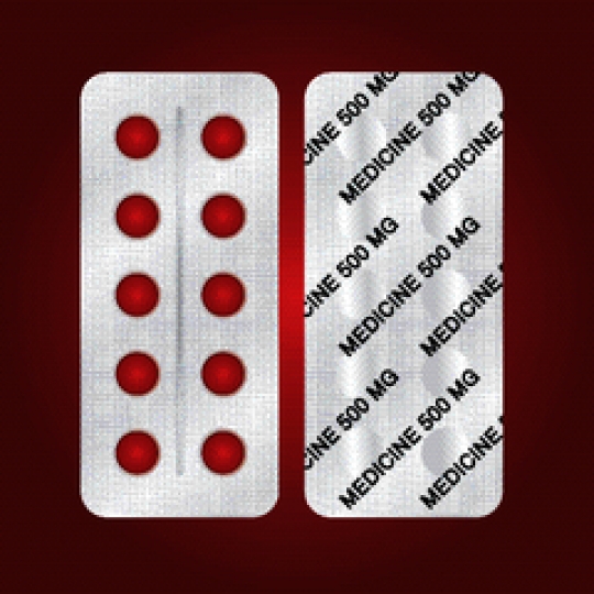 round pills in blister pack on red background