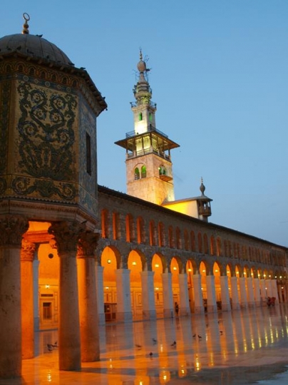 a yard with minaret of a mosque