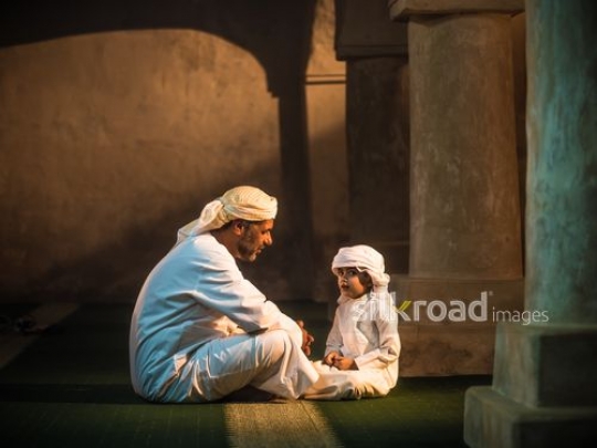 Grandfather and grandson at the mosque|-