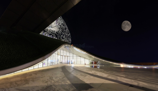 Dubai's Futuristic Building with Moonlit Night Sky